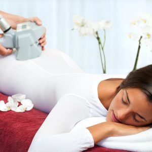 Therapist applying anti cellulite lipomassage on womans body.